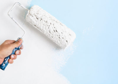 Close up of painter hand painting a wall